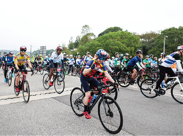 Cyclists riding on a highway bridge over the sea